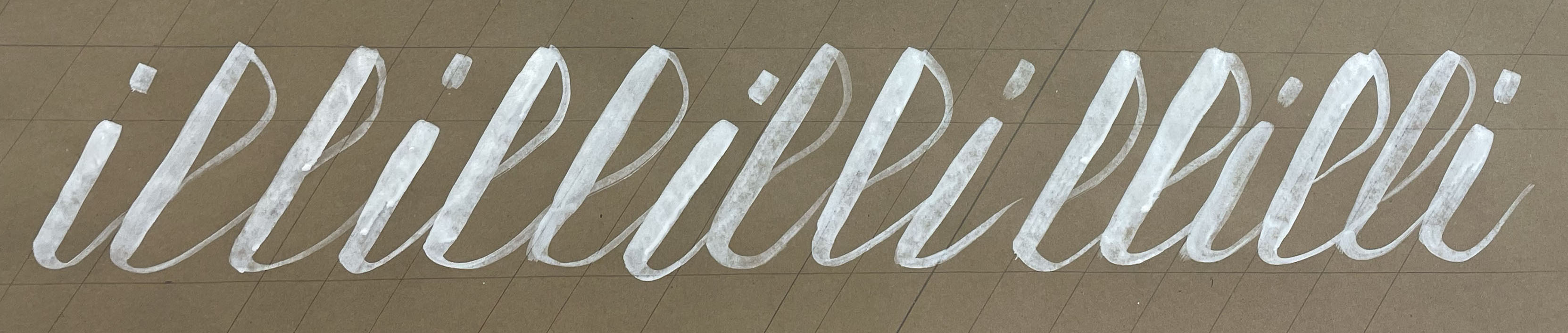 hand-lettered calligraphy on brown paper with white paint